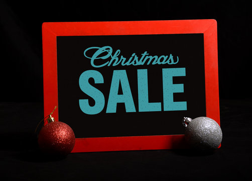 After Christmas Sale in chalkon a black chalkboard with balls
