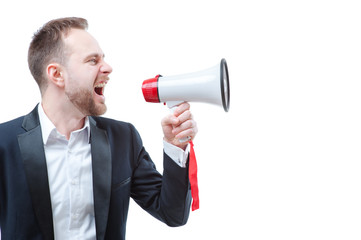 Fototapeta premium Shouting louder! Studio portrait of young businessman using megaphone. Isolated on white.