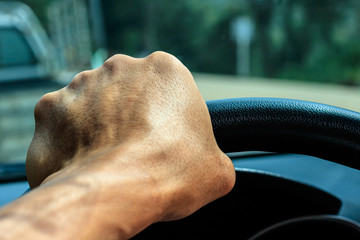 hand Man driving on the road 