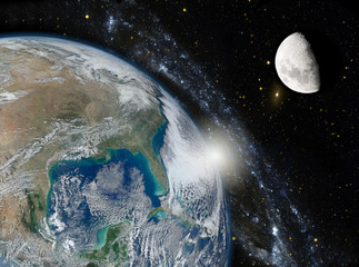 Earth, the galaxy and the moon. Elements of this image furnished by NASA.