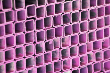 stack of pink metal pipe