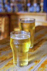 Two beers on a bar
