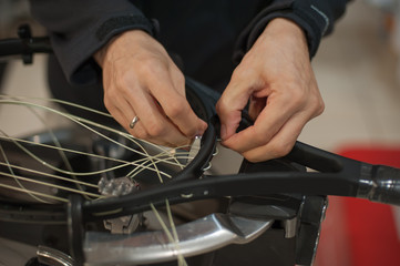 Stringing Machine. Close up of tennis stringer hands doing racket stringing in his workshop