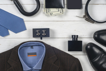 set of men's clothing and shoes on wooden background.