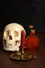 candle with potion bottles and skull