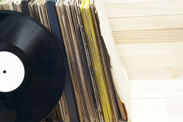 Browsing through vinyl records collection. Music background. Copy space