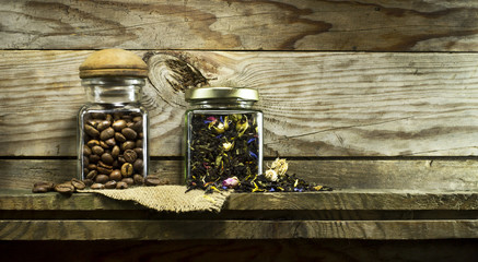 Coffee beans and dry tea in glass jars