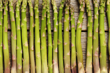 Fresh green asparagus on a grey wooden table