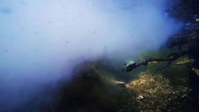 handheld underwater shot of polluted dirty drain water