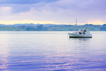 Fototapeta premium Sailboat on water with beautiful landscape at the background.