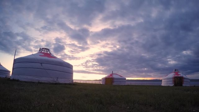 Timelapse of sunset behind mongolian yurt