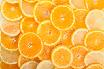 citrus background. juicy slices of lemon and orange cover the entire surface. 