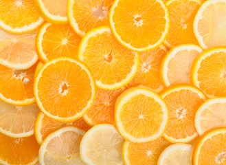 citrus background. juicy slices of lemon and orange cover the entire surface. 