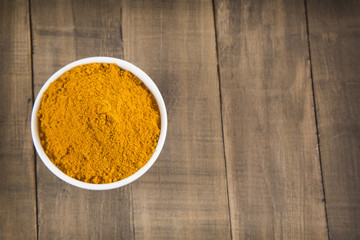 Turmeric powder on wooden table