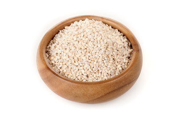 pearl barley in a wooden bowl. for healthy cooking ingredient