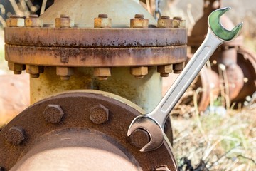 Shining new Wrench on a rusty bolt