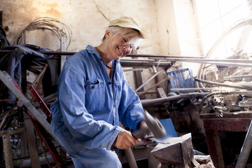 beautiful lady at work in his old workshop