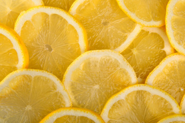 citrus background. juicy slices of lemon  cover the entire surface.