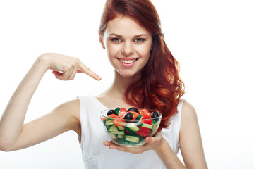 Beautiful woman eating a salad. Isolated background
