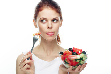 Beautiful woman eating a salad. Isolated background
