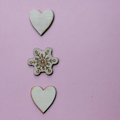 Wooden Christmas, Wedding or Valentine favors on a pink background