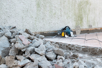 Repairing the house terrace and professional pneumatic hammer drill perforator
