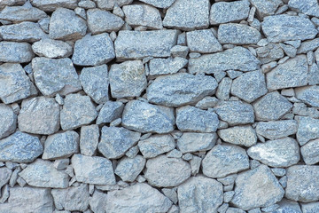Blue ancient stone wall built for exterior for background