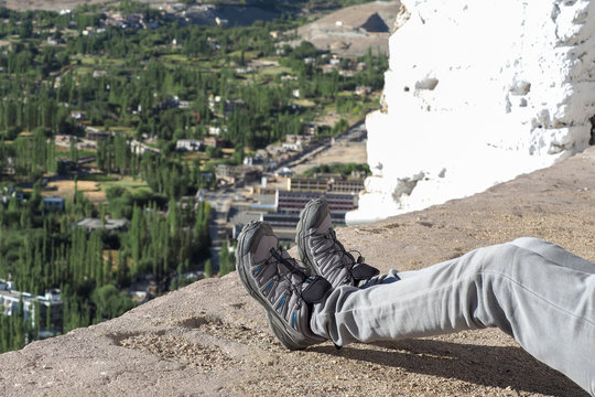 Hiker's boots relaxing and resting his feet on high mountain trekking scene and adventure