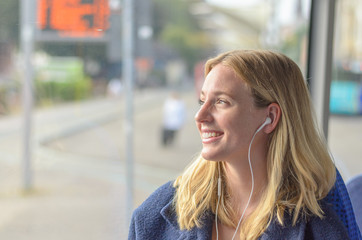 Attractive smiling woman listening to music