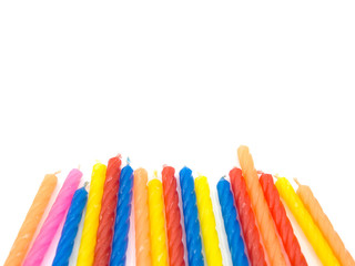 multiple color birthday candles on the white background located