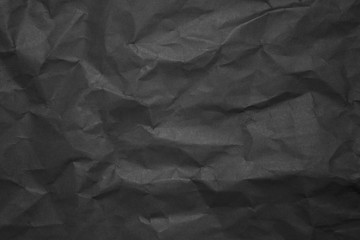 Black creased paper background texture