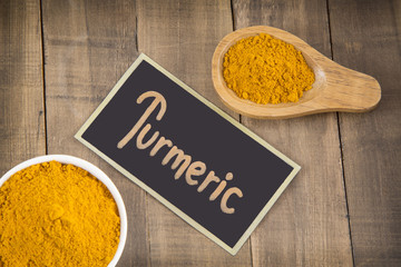 Turmeric powder on wooden table