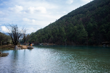 White Water River (Baishui River) with Jade Dragon Snow Mountain background in Blue Moon Valley of...