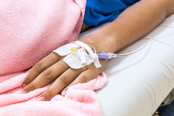 Obraz na płótnie Canvas Patient hand in hospital with saline intravenous iv