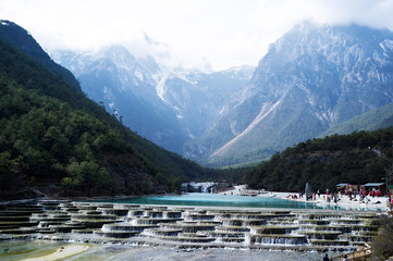White Water River (Baishui River) with Jade Dragon Snow Mountain background in Blue Moon Valley of...