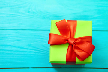 Gift box on blue wooden background with copy space. Top view and selective focus