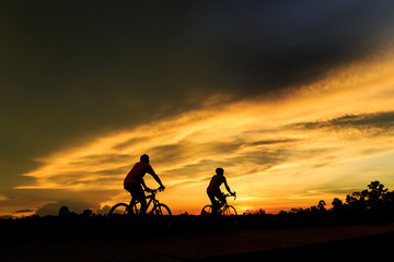 Fototapeta na wymiar silhouette of people riding bicycle for health