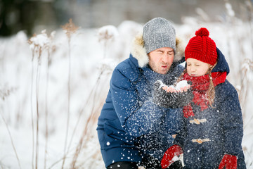 Father and daughter outdoors at winter