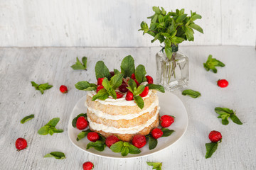 Homemade cake decorated strawberry and mint on white background