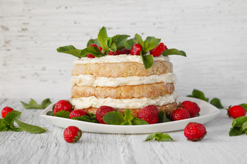 Homemade cake decorated strawberry and mint on white background