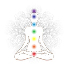 Chakras concept. Silhouette in lotus position over gray ornate m