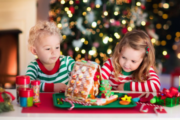 Kids making Christmas ginger bread house