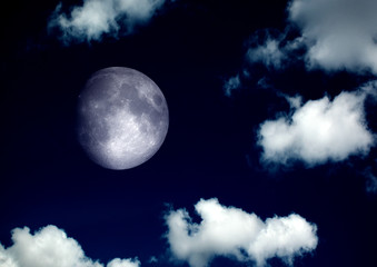 Obraz na płótnie Canvas The moon in the night sky in clouds