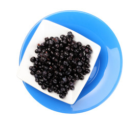 blackberry on white plate over blue plate. view above
