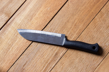 Kitchen knife on wooden board background