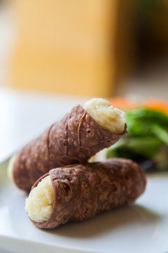 Two Tasty Cannoli on a Plate.
