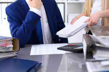 Bookkeeper or financial inspector and secretary making report, calculating or checking balance....