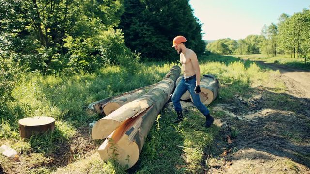 Lumberjack with an ax . Woodcutter with naked torso in the coniferous forest.
