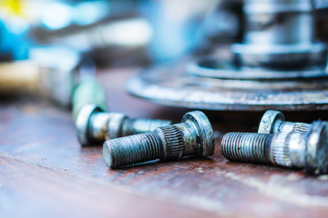Old, oiled wheel hub lies on a wooden table