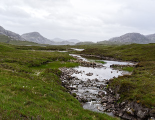 A stream of water through the fell in the mountains.
